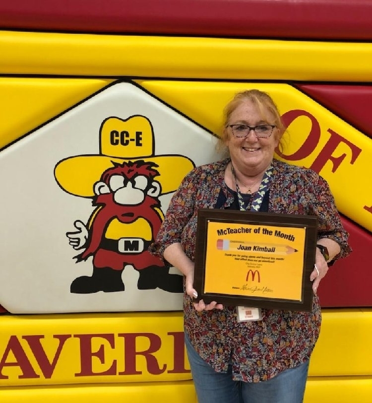 teacher with award
